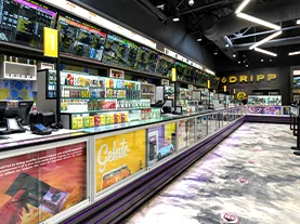 Interior view of Cannabis 21+ dispensary showing lines of products on shelves