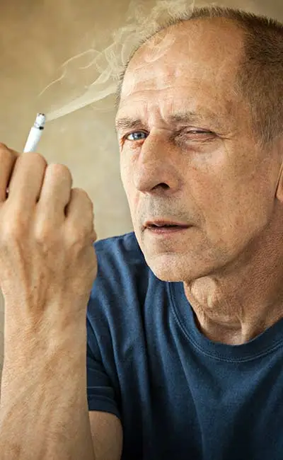 Elderly man smoking a joint