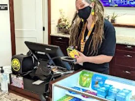 Retail staff at the counter at C21+ Ukiah dispensary